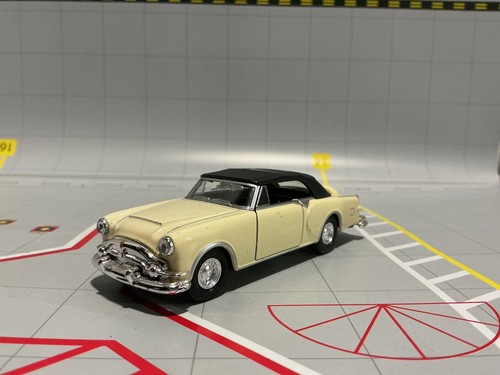 1:43 WELLY #43665 1953 PACKARD CARIBBEAN YELLOW WITH BLACK TOP