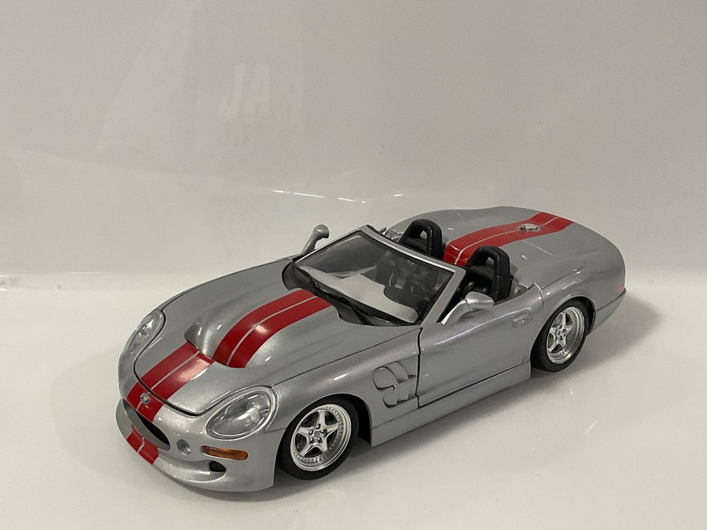 1/18 BURAGO SHELBY SERIES 1 1999 GRAY/RED ON BLACK/GRAY